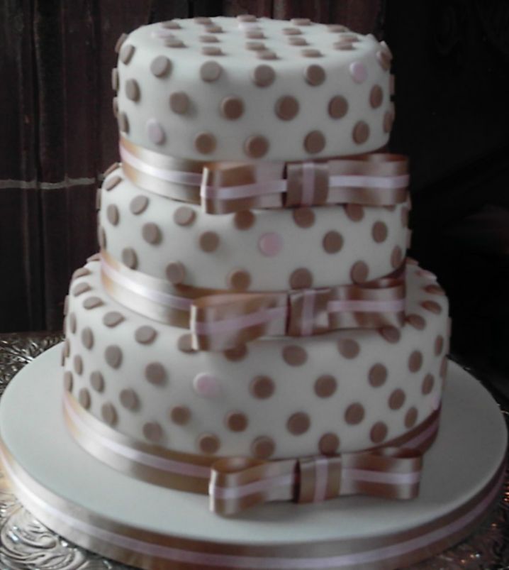 Three tier weddding cake with pokadots and bowties.JPG