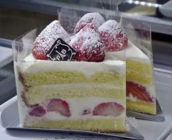 Moist Strawberry Shortcake with white cream and powdered sugar.JPG