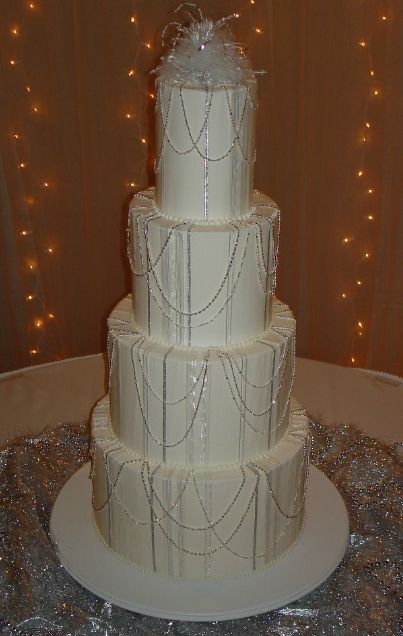 Four tier wedding cake with bead strings.JPG