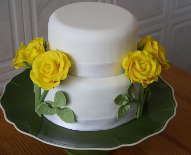 Two tier white small wedding cake with yellow roses.JPG