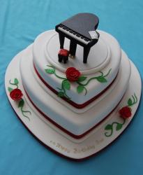 3 tier heart-shaped birthday cake with roses and black piano on top.JPG