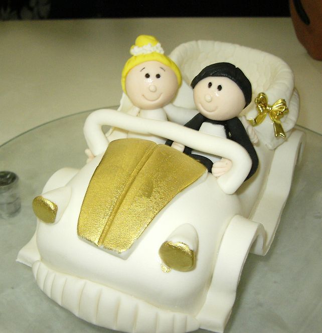 Bride and Groom in a buggy wedding cake topper.JPG