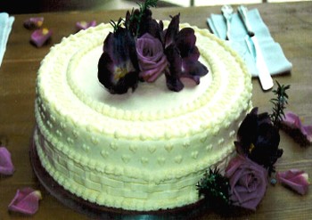 a single wedding cake with black roses topper