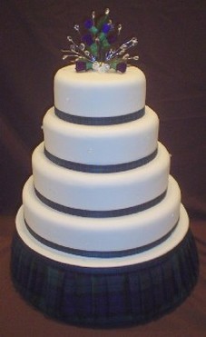 trendy wedding cake with green ribbons