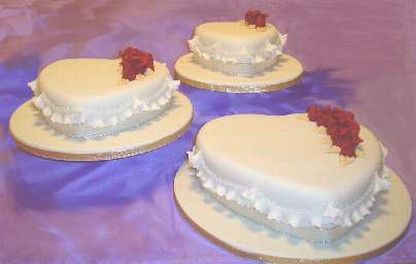 Heart shaped wedding cakes with red flowers