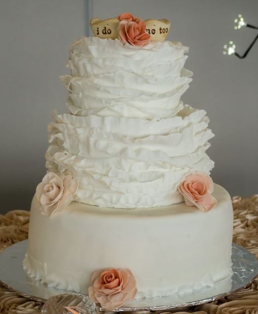 Three tier ruffled wedding cake with pink roses.JPG
