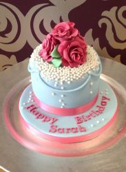 Powder blue birthday cake for woman with roses and pearls on top.JPG