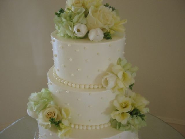 Wedding cake in ivory with light yellow flowers