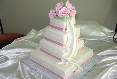 princess wedding cakes in four tier with fresh pink roses topper