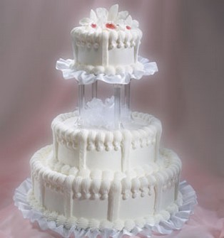 Picture of cream wedding cake with three tier with cute topper