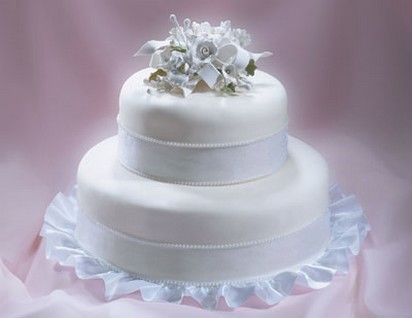 Two tier smoth wedding cake white floral topper
