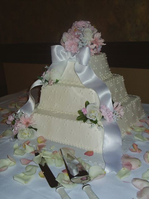 Square Wedding Cakes with pink flowers and white ribbon