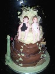 groom and bride in swimming suites wedding cake