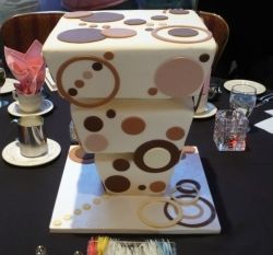 Three tier square modern artsy cake with circles.JPG