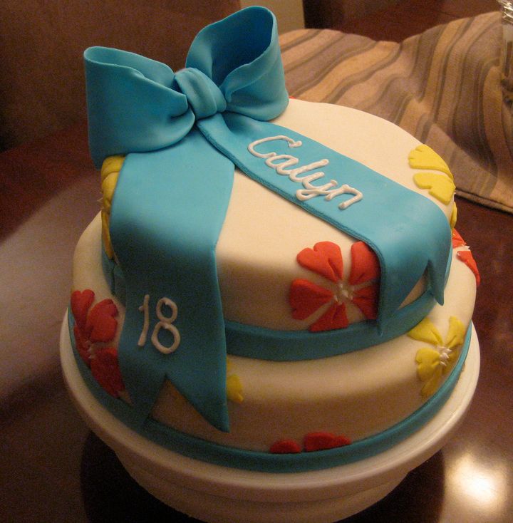 Two tier round birthday cake with blue bowtie.JPG