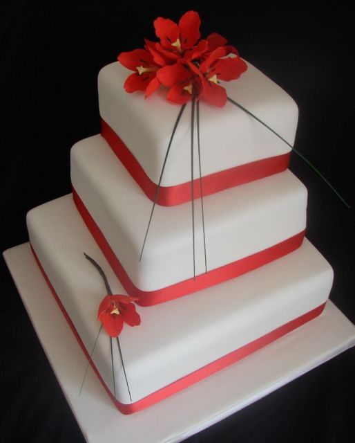 White three-tier wedding cake with red tulips.JPG
