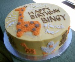 Round Birthday cake with giraffe and other animals.JPG