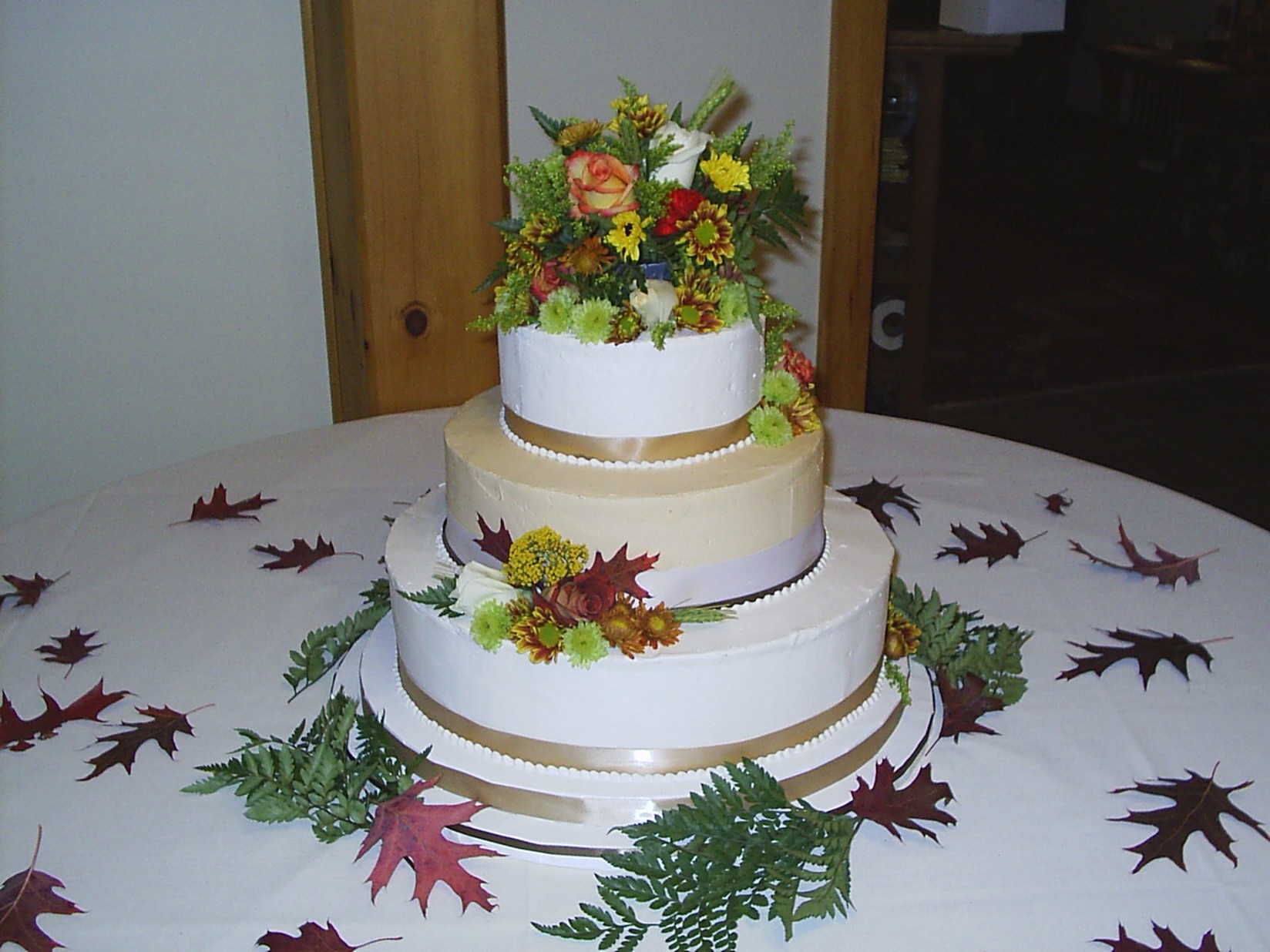 Wedding Cakes in two different colors and full of fresh flowers picture