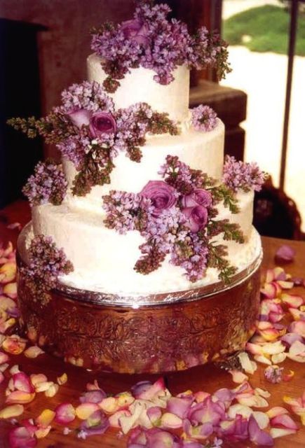 wedding cake with fresh purple flowers