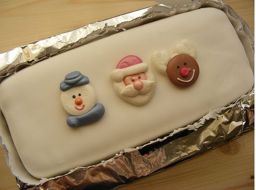 Simple white Christmas cake with Santa faces.JPG