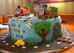 Thomas and friends cake decorations with Thomas, Percy and James on the rails with car cake driving on the road_cute kids birthd