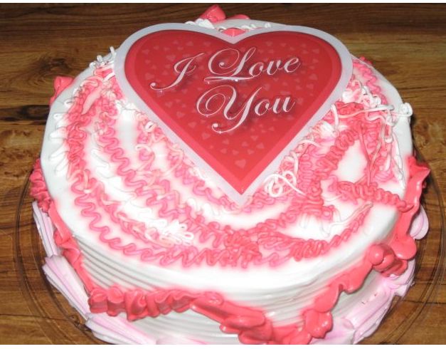 Pink valentines cake with heart in center.JPG