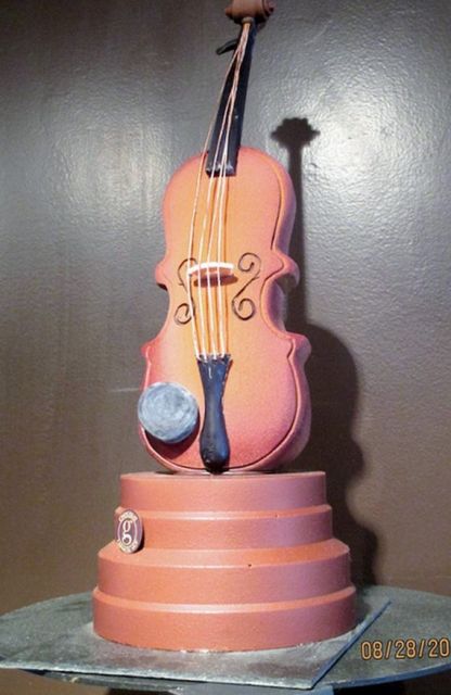 Sculped guitar cake.JPG