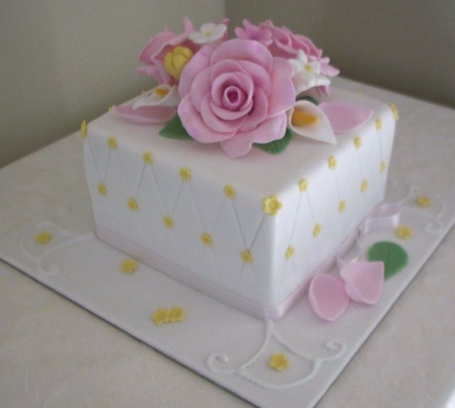 White cubic birthday cake with pink flowers.JPG