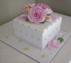 White cubic birthday cake with pink flowers.JPG