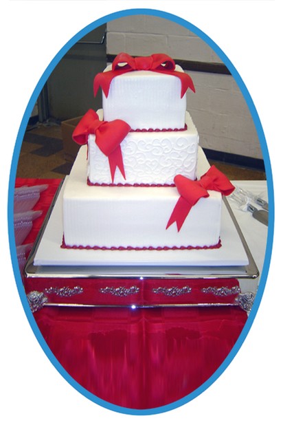 square Tuscola Wedding cake with red bows.jpg
