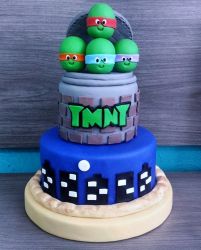 3 Tier TMNT Cake with Turtle Heads on Top.JPG