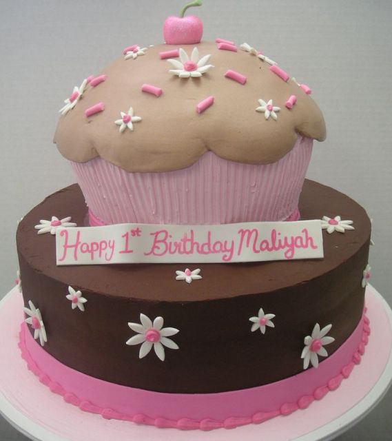 Two tier birthday cake with big cupcake on top.JPG