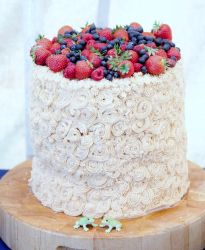 Cylindrical Cream Swirl Cake with Fresh Berries on Top.JPG