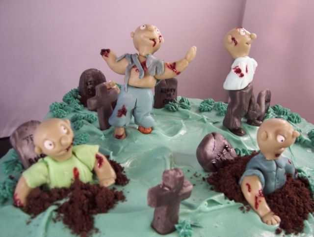 Zombie birthday cake with full of cute fondant zombies.JPG