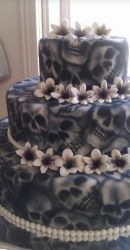 Skull cakes in three tiers with skull prints and flowers.JPG