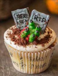 Scary cupcake with grave yard theme cake.JPG
