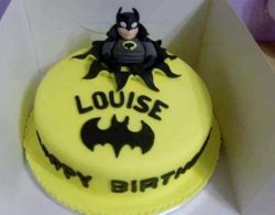 Batman Bursting Out of Yellow Birthday Cake.JPG