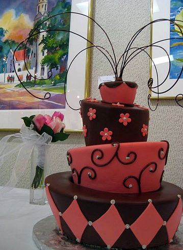 Four tier topsy turvey brown and pink cake.JPG
