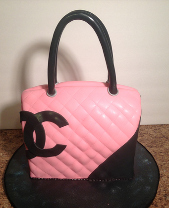 Chanel black pink cake with large Chanel logo.PNG