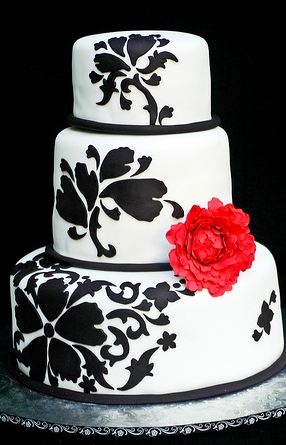 Three tier white round damask wedding cake with red flower.JPG