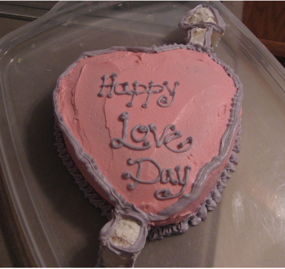 Valentine cake homemade in light pink with purple patterns.PNG