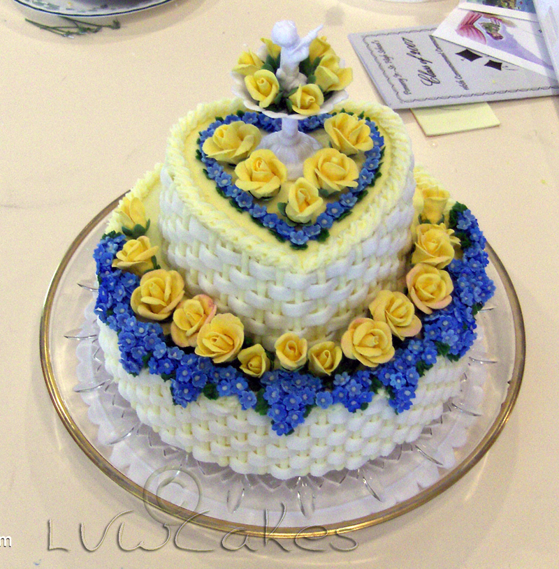 Elegant two tier white basket cake with small yellow roses.JPG