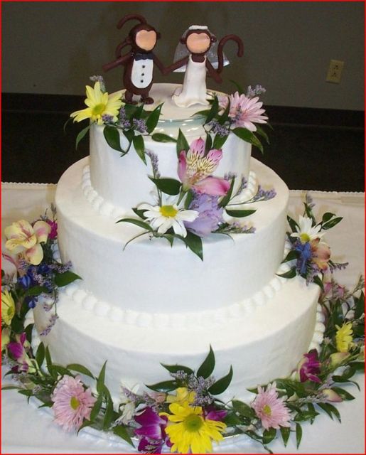 White butter cream wedding cake with Monkey topper.jpg