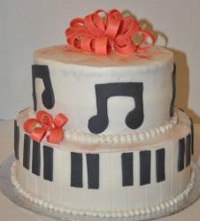 Two tier white piano and music theme cake.JPG