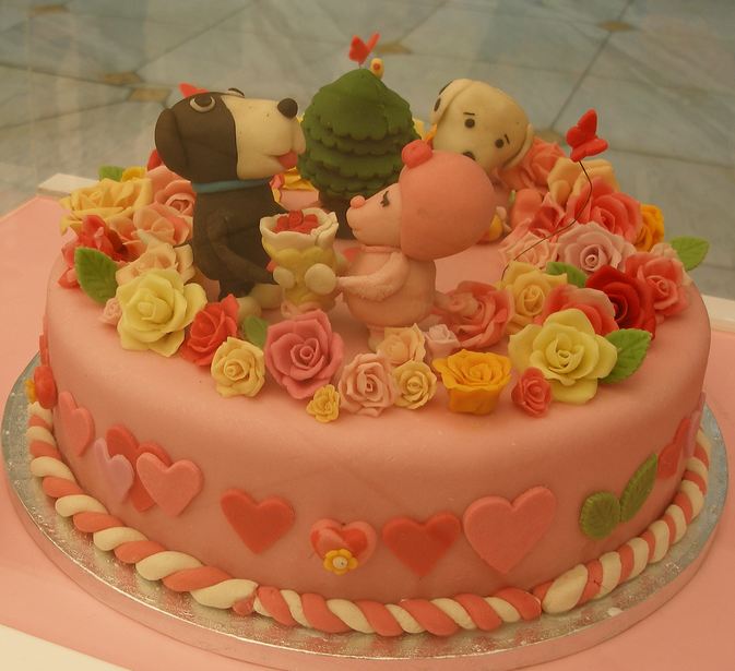 Pink Valentines cake with puppy dogs and hearts.JPG