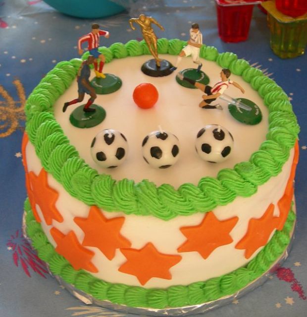 Soccer theme cake with soccer balls as candles.JPG