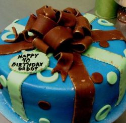 Blue round birthday cake with chocolate bow.JPG