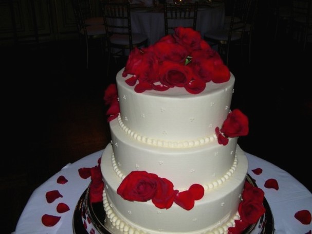 three tier white with red flowers wedding cake