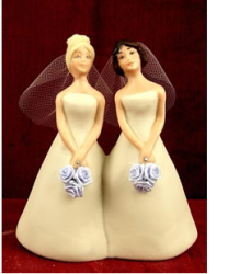 Picture of lesbian wedding cake toppers in their pretty light yellow bride gowns.PNG