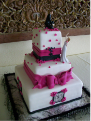 Romantic theme wedding cake with groom on very top tier and bride on the second tier looking up.PNG